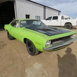 1970 Plymouth Barracuda, a very desirable and iconic muscle car from the era, green with white interior. Note: the car has no engine or transmission.