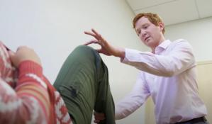 Dr. Lilley examines a patient's knee