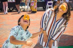 Mom and son enjoy themselves competing in the donut-eating contest.