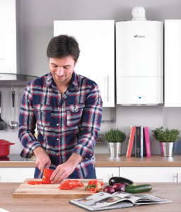 A man in a house with a well-maintained boiler.