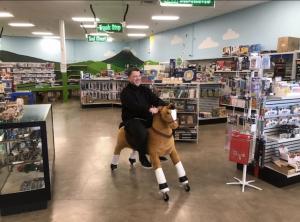 Man rides toy horse