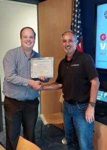 Global Ventures Program Manager, Ryan Lilly presents FloSpine CEO, Peter Harris his graduation certificate