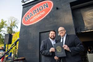 Photographer, Chris Marion poses with Springfield City Council President Jesse Lederman during Marion's studio Grand Opening ceremony.