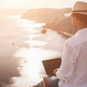 Man with a laptop overlooking Marbella, Spain