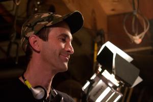 Writer/Director Gregory Blair beside a light on the set of "Deadly Revisions"