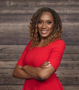 Dr. Latrice Rollins, Director & Principal Investigator, NAACFRC, stands in a red dress