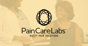 Image of patient getting blood draw from doctor behind Pain Care Labs logo