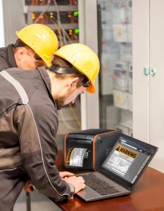 LabelForge PRO displayed on a computer screen as a safety professional creates facility specific custom label about electrical dangers.