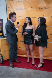 This is a picture of two women, a mother and a daughter, on the red carpet at the launch party for author Sarah Arcuri's launch party of "The Owner & The Wife" hosted at Fresco Da Franco in Montclair, New Jersey.  The mother's name is Irene and she is a f