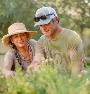 Martha and Curt Van Inwegen, The Heart of Life Elements Wellness Products carefully collecting farm fresh ingredients.