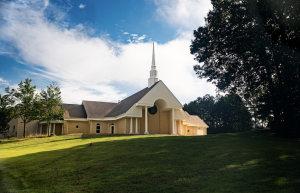 The Unitarian Universalist Congregation of Atlanta Church Building feature a steeple with no religious imagery and a wide green lawn