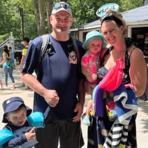 family of four taking photo in front of water area at Splish Splash