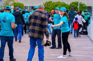 Drug-Free World volunteers hand out booklets to those arriving for the Monster Jam at SoFi Stadium.