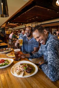 Two men drinking beer and enjoying the Hoppy Father's Day menu at Iron Hill Brewery