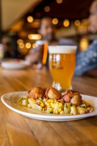 The Scallops & Bacon appetizer on the Hoppy Father's Day menu from Iron Hill Brewery next to a delicious golden beer