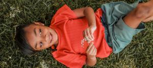 Child wearing Jackalo's organic clothing that they buy back to be renewed and resold or responsibly recycled.