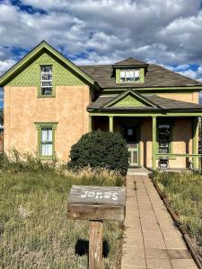 The stucco colored Jones home from Last Crusade movie is pictured with green trim and mailbox that reads Jones.