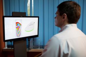 orthopaedist at work with digital footstep model