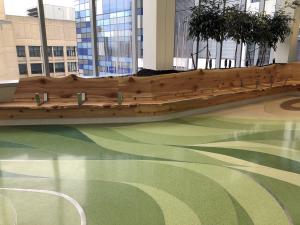 Terrazzo patterning respresents the lost Dawn Redwood tree, framed by wooden benches.