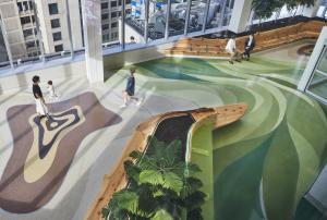 Patterns in terrazzo represent a cross-section of the tree's trunk surrounded by green, signifying the leaves.