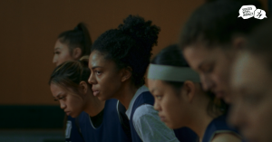 Team of teen athletes on the sideline of a game with Voices With Impact logo in the top right corner.