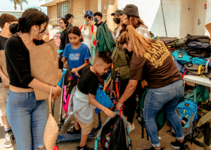 Volunteers distribute backpacks to young guests at Project Boon's 2022 Back-to-School Backpack Event