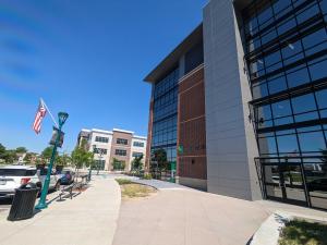 The outside of the new LexxPluss office building at Fischers, Indiana, waving the American flag.