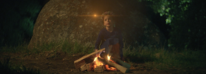 Still image of little girl at campfire from LITTLE WINGS, a film by Mateo Messina