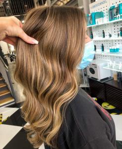 Client with long, honey blonde hair which is wavy
