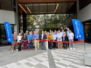 Ribbon cutting with the team in front of the new Technology Delivery Center