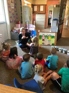 ATSPA staff sitting with group pf kids during a safety information session