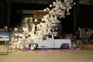 Balloons fall on the Roaster Shop OBS built Goodguys giveaway truck.