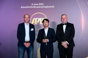 Caton receiving APB+ Sports Broadcasting Award 2023