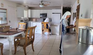 A wide shot of the kitchen where the Sisters are working.