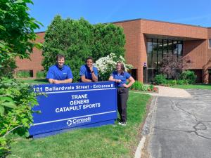 Three members of the Gener8 Boston Team in front of new building