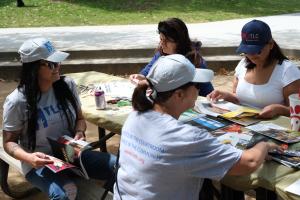 Photo of women creating vision boards. LATLC proudly sponsored a highly successful women's empowerment event, activities included creating vision boards.