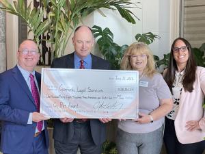 Award recipients holding large check