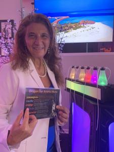 Image: Dr. Dalal Akoury stands beside the Oxygen Bar at AWAREmed, offering a serene and revitalizing space for holistic wellness and vitality.