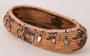 Finely-woven, oval Pomo gift basket featuring stepped diamonds, triangles and motifs, plus a rim lined with clamshell discs and glass beads, plus bead and abalone shell pendants ($4,875).