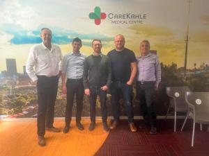A photo of Japie, Bruce, Chris and guests at the Care Kahle Medical Centre in Alexandra