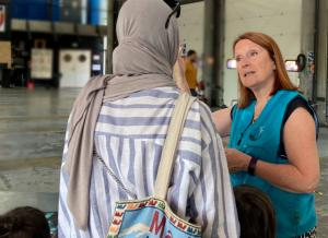 At a booth in Paris, a volunteer shares the Truth About Drugs campaign with a mother.