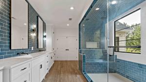 massive walk-in shower with steam shower capabilities and a completely tiled bench at one end