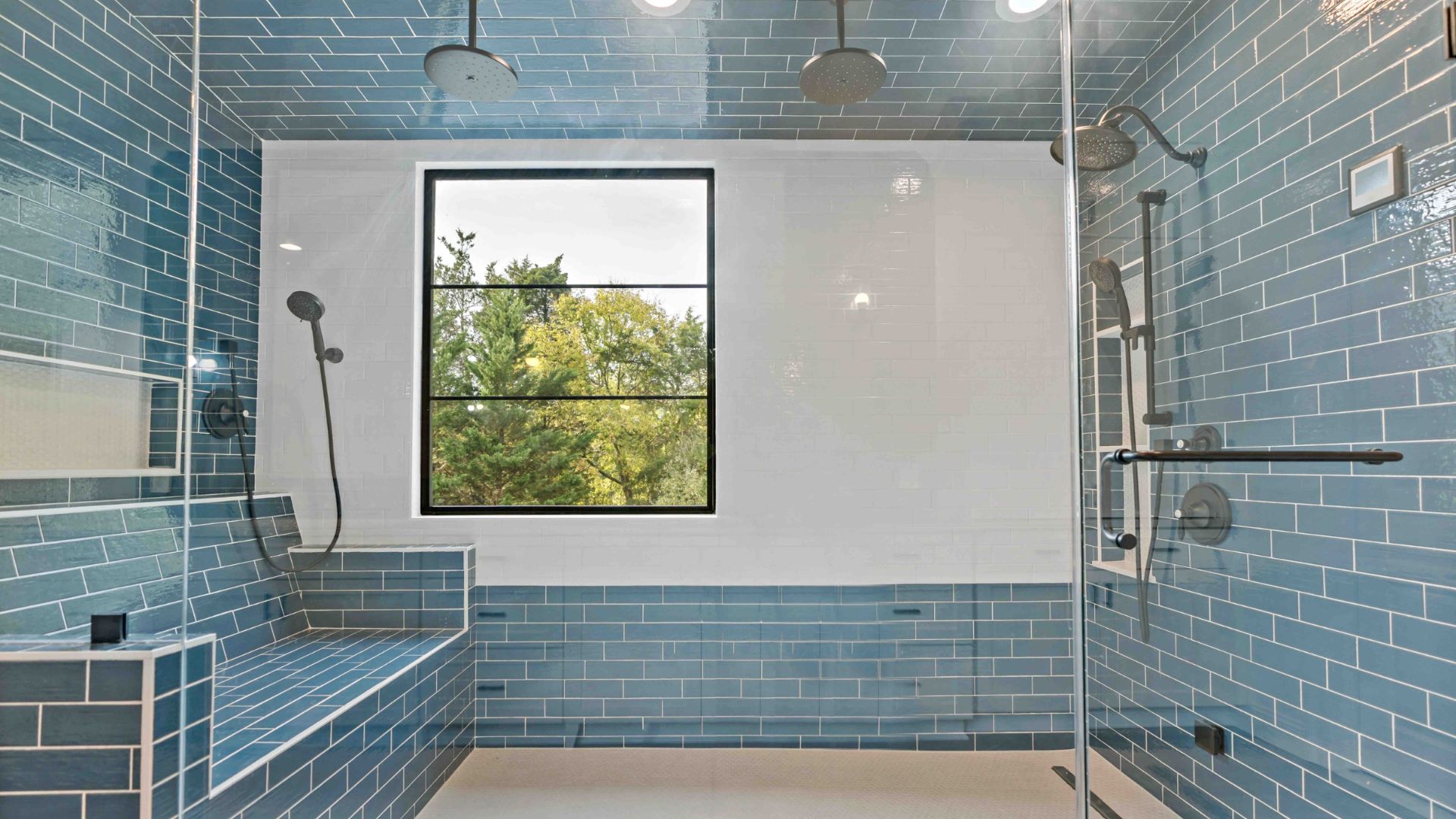 large, fully tiled bench at one end of the walk-in shower. It is designed so that one can comfortably sit and enjoy a steam shower akin to a sauna experience.