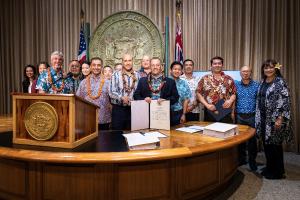 From left to right (front row): Michael Costa (Highridge Costa), Moe Mohanna (Highridge Costa), Hakim Ouansafi (HPHA), Hawai‘i Governor Josh Green are joined by HPHA staff and other elected officials in the Governor’s Office in downtown Honolulu for the a
