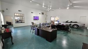 Large welcoming lobby of the new Corporate Collision Centers with an antique car in the corner