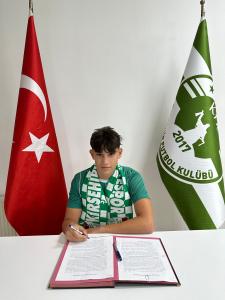 Turkish Canadian young football player signing first professional contract in the Turkish Football League