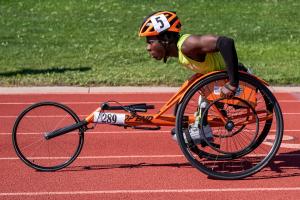 Athlete in a racing wheelchair on the track