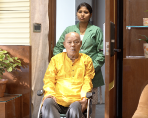 Caregiver helping a senior citizen in India