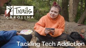 Trails student plays UNO in nature with her peers.