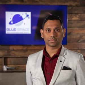 A man is pictured in front of his company's logo.